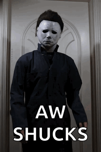 A Man In A Mask Is Standing In Front Of A Door With The Words Aw Shucks Written On The Bottom GIF