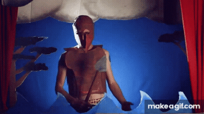 A Man In A Mask Is Standing In Front Of A Red Curtain . GIF