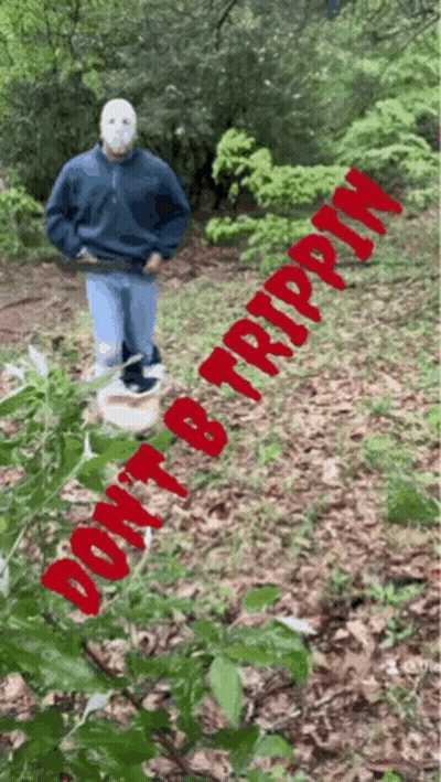 A Man In A Mask Is Standing In The Woods With The Words " Do N't B Trippin " Written In Red GIF
