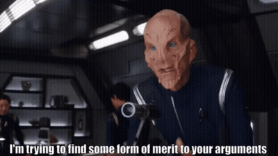 A Man In A Mask Says I 'M Trying To Find Some Form Of Merit To Your Arguments While Holding A Gun GIF