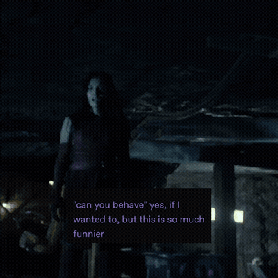 A Man In A Mask Stands In A Dark Room With A Green Light Behind Him GIF