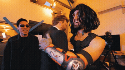 A Man In A Matrix Costume Is Being Hugged By Another Man GIF
