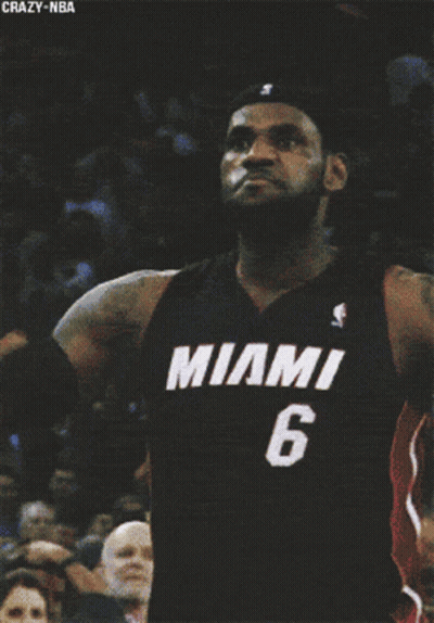 A Man In A Miami 6 Jersey Is Dancing In Front Of A Crowd GIF