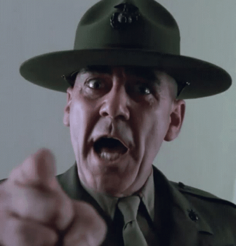 A Man In A Military Uniform And Hat Is Pointing GIF