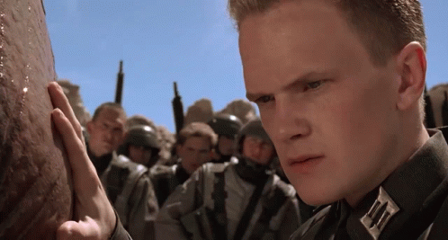 A Man In A Military Uniform Has A Badge On His Chest That Says " A " GIF
