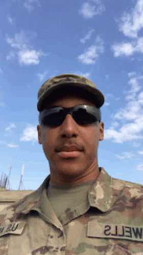 A Man In A Military Uniform Has A Patch That Says 2J3w On It GIF