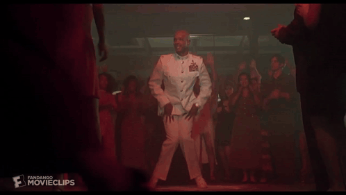 A Man In A Military Uniform Is Dancing In Front Of A Crowd Of People With The Word Movieclips On The Bottom Right GIF