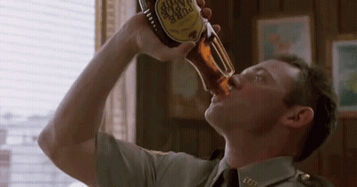 A Man In A Military Uniform Is Drinking A Bottle Of Pure Taste GIF