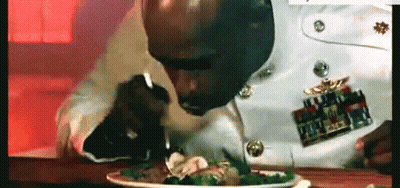 A Man In A Military Uniform Is Eating A Salad With A Fork . GIF