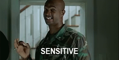 A Man In A Military Uniform Is Holding A Cigarette In His Hand And Saying `` Sensitive '' . GIF