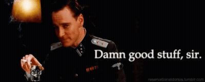 A Man In A Military Uniform Is Holding A Glass And Smoking A Cigarette GIF