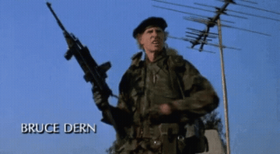 A Man In A Military Uniform Is Holding A Gun And The Name Bruce Dern Is On The Bottom GIF