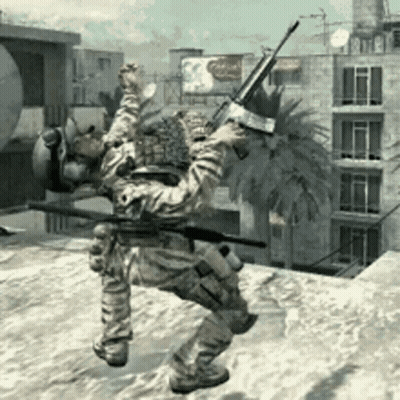 A Man In A Military Uniform Is Holding A Gun In Front Of A Palm Tree GIF