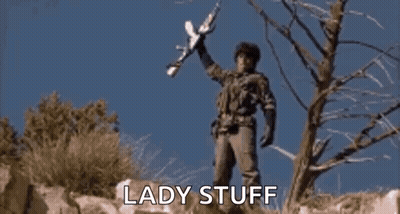 A Man In A Military Uniform Is Holding A Rifle And Says Wolverines !!! GIF