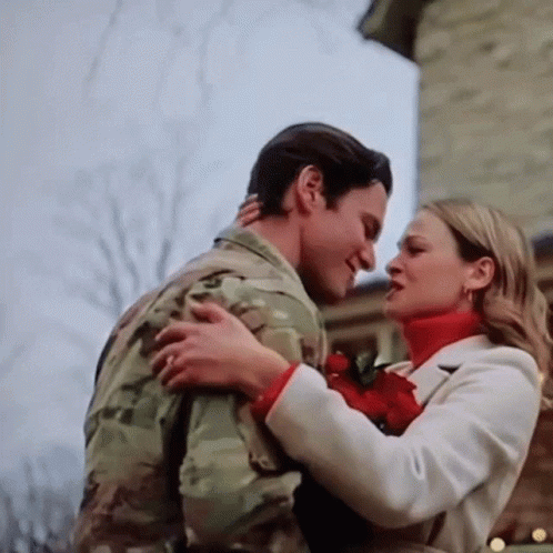 Man In Military Uniform Hugging Woman In White Coat GIF