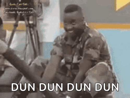 A Man In A Military Uniform Is Kneeling Down With The Words Dun Dun Dun Dun Written On The Bottom . GIF