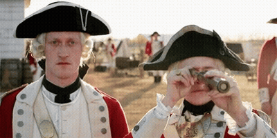 A Man In A Military Uniform Is Looking Through A Telescope . GIF