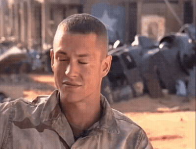 A Man In A Military Uniform Is Making A Funny Face . GIF