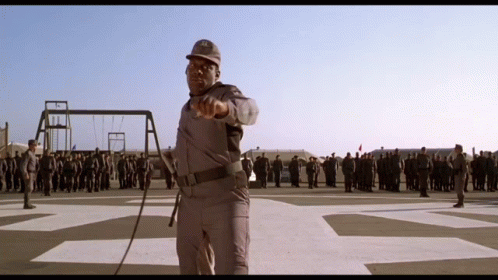 A Man In A Military Uniform Is Pointing At A Group Of Soldiers GIF