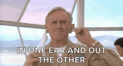 A Man In A Military Uniform Is Putting A Hearing Aid In His Left Ear . GIF