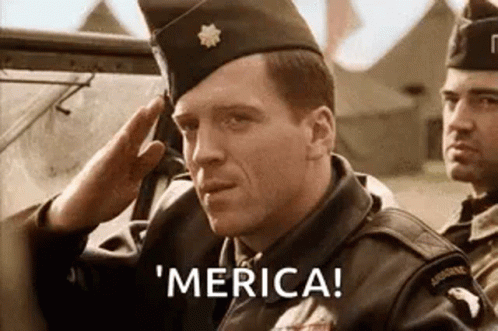 A Man In A Military Uniform Is Saluting While Another Man Says ' Merica ' . GIF