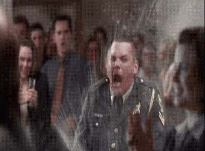 A Man In A Military Uniform Is Screaming In Front Of A Crowd Of People At A Party . GIF