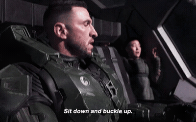 A Man In A Military Uniform Is Sitting Down And Buckle Up GIF