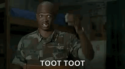A Man In A Military Uniform Is Sitting In A Bunk Bed And Pointing At The Camera . GIF