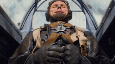A Man In A Military Uniform Is Sitting In A Cockpit GIF