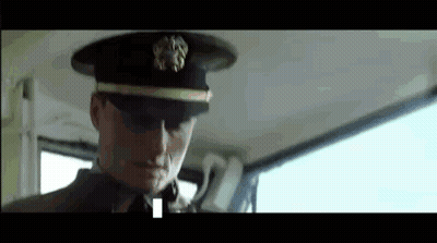 A Man In A Military Uniform Is Sitting In The Back Seat Of A Car . GIF