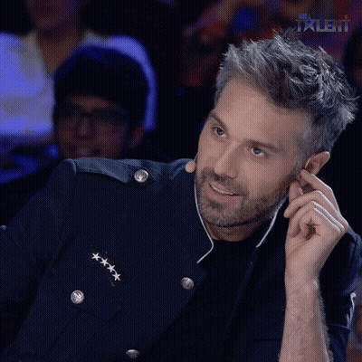 A Man In A Military Uniform Is Smiling And Talking On A Cell Phone In Front Of A Talent Logo GIF
