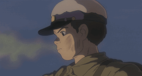 A Man In A Military Uniform Is Smiling With His Tongue Out GIF