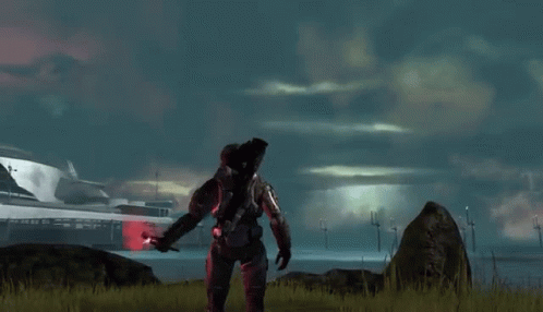 A Man In A Military Uniform Is Standing In A Field With A Red Object In His Hand . GIF