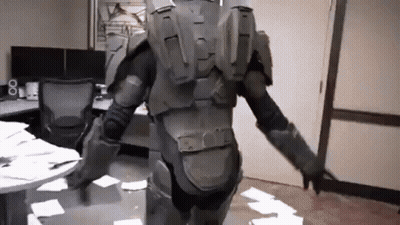 A Man In A Military Uniform Is Standing In A Room With A Lot Of Papers On The Floor . GIF