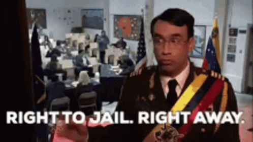 A Man In A Military Uniform Is Standing In Front Of A Crowd Of People And Says Right To Jail Right Away . GIF
