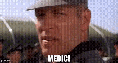 A Man In A Military Uniform Is Standing In Front Of A Crowd Of People . GIF