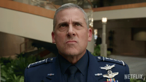 A Man In A Military Uniform Is Standing In Front Of A Netflix Sign GIF