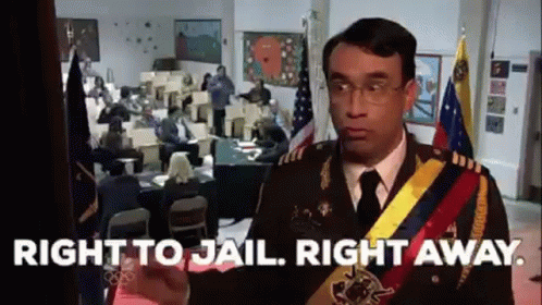 A Man In A Military Uniform Is Standing In Front Of A Room With People Sitting At Tables . GIF