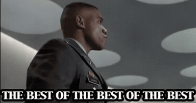 A Man In A Military Uniform Is Standing In Front Of A Sign That Says The Best Of The Best GIF