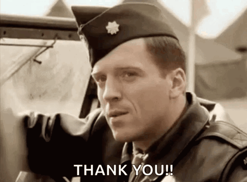 A Man In A Military Uniform Is Standing Next To A Car And Says `` Thank You '' . GIF
