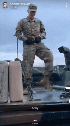 A Man In A Military Uniform Is Standing On Top Of A Military Vehicle With The Words Army Chat Below Him GIF