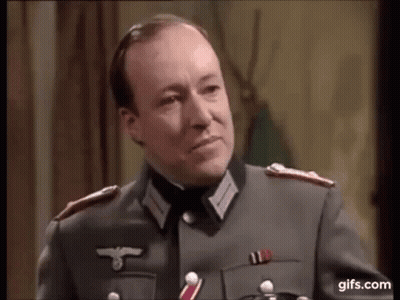 A Man In A Military Uniform Is Talking To Another Man . GIF