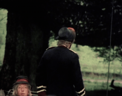 A Man In A Military Uniform Is Talking To Another Man In A Car GIF