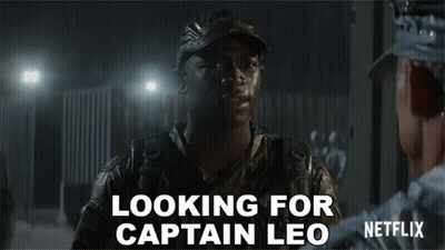 A Man In A Military Uniform Is Talking To Another Man In A Dark Room And Says `` Looking For Captain Leo '' . GIF