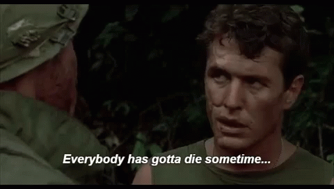 A Man In A Military Uniform Is Talking To Another Man In A Forest . GIF