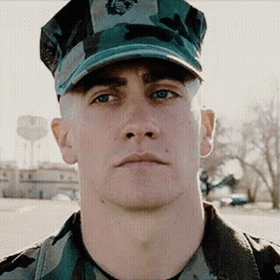 A Man In A Military Uniform Is Wearing A Hat That Says Marines On It GIF