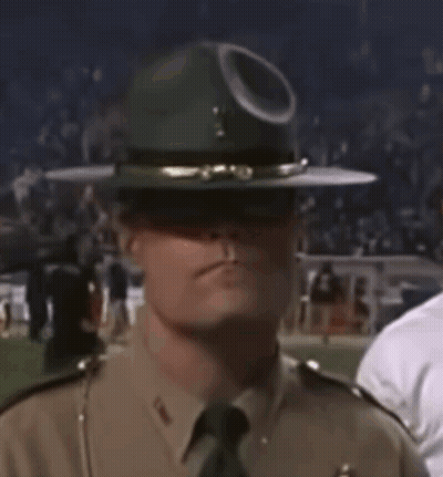 A Man In A Military Uniform Is Wearing A Hat With A Hole In It GIF