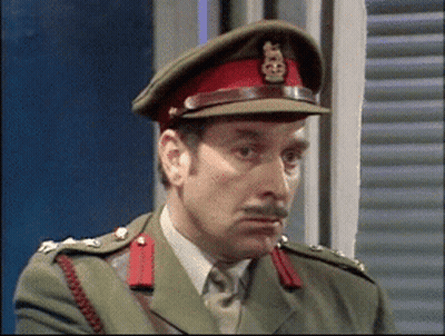 A Man In A Military Uniform Is Wearing A Red Hat With A Gold Emblem On It GIF