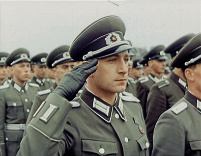 A Man In A Military Uniform Salutes In A Line GIF