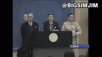 A Man In A Military Uniform Stands Behind A Podium Giving A Speech To A Crowd . GIF